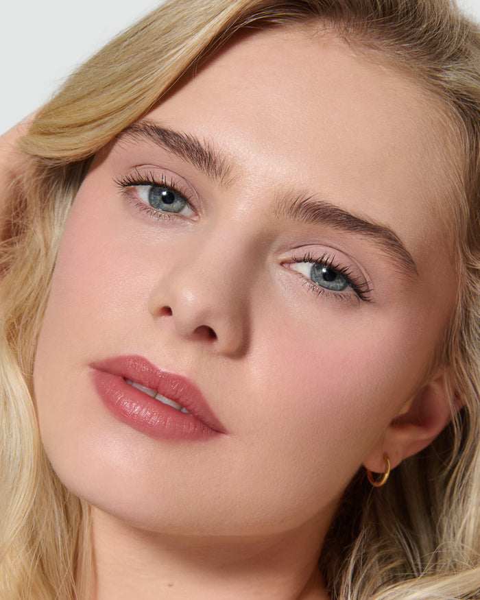 Close up of a model wearing Paige Liquid Silk Eyeshadow on a neutral background