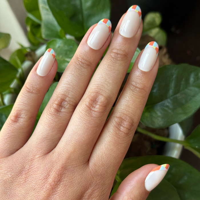 Parade French - Press-On | Medium | Oval with colorful geometric checker tips on natural nails for easy at-home manicure