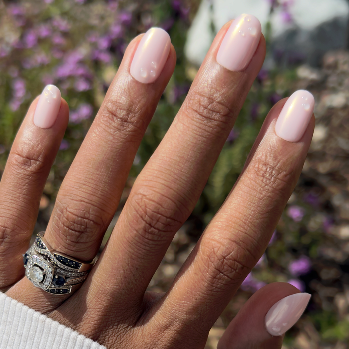 Pink Bubble Pearlescent - Press-On | Short | Round with shiny pink polish and subtle bubble accents on natural hand