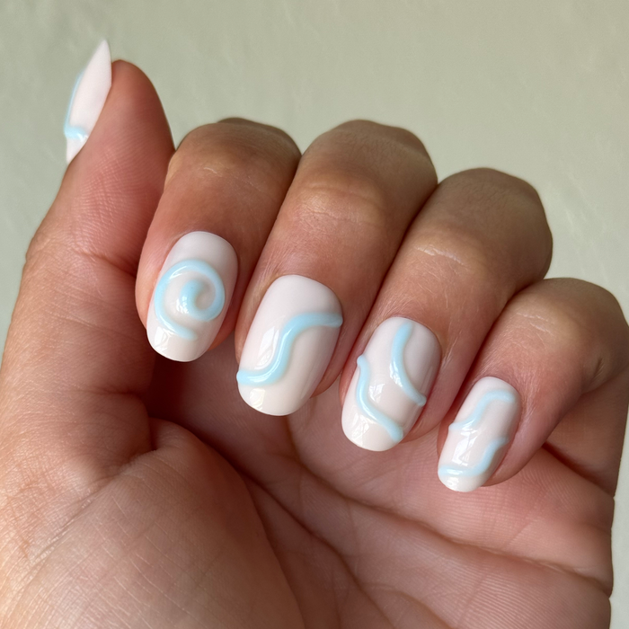 Puffy Swirls - Press-On | Short | Round neutral nails with raised light blue swirl accents for easy at-home manicure