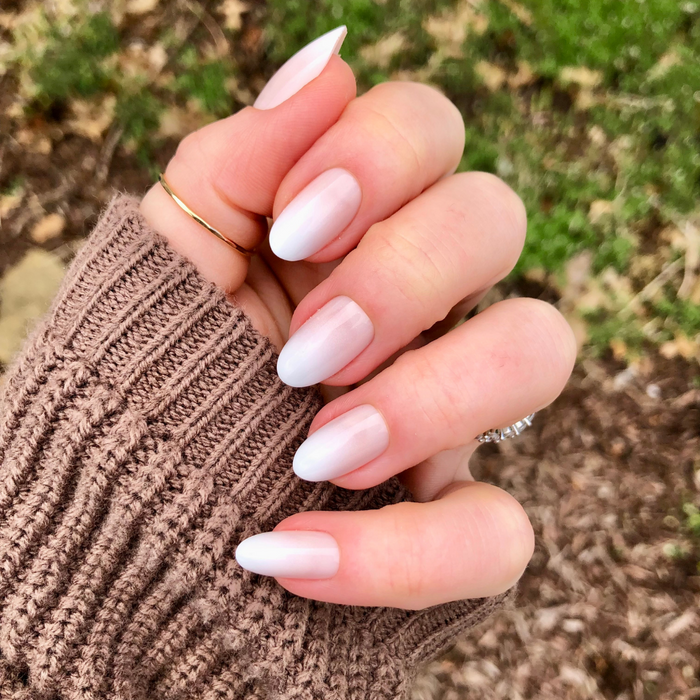 Pure White Syrup Gradient - Press-On | Medium | Oval showing hand with medium oval bright white gradient press-on manicure outdoors