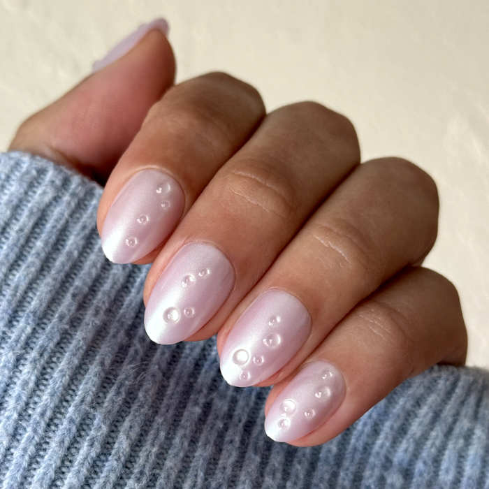 Purple Puka Raindrops - Press-On | Short | Almond featuring iridescent lavender nails with raised 3D raindrop details for mani