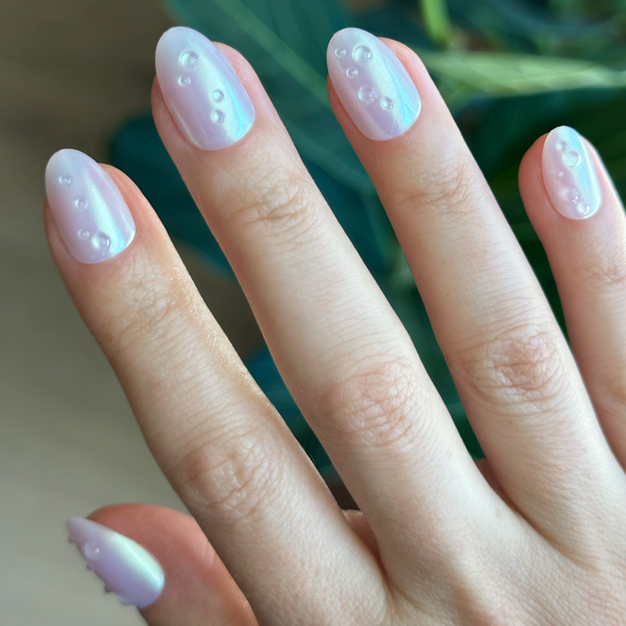 Purple Puka Raindrops - Press-On | Short | Almond showcasing iridescent lavender nails with raised 3D raindrop accents for easy mani
