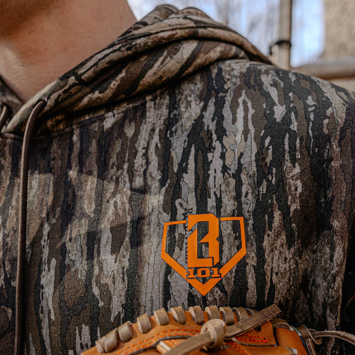 Person wearing a camouflage hoodie with an orange BL101 logo, holding a bow and arrow.