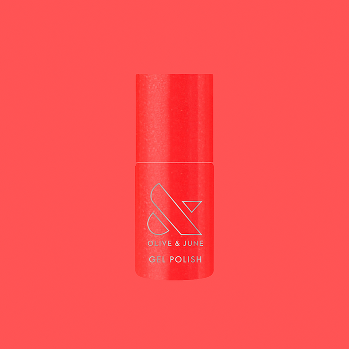 Bottle of Rodeo Queen - Gel nail polish in bright pinky-red with silver shimmer by Olive and June on red background