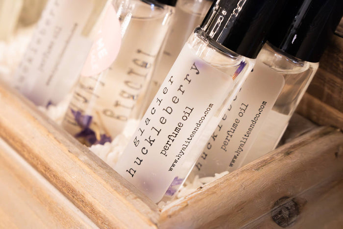 Hyalite & Co roll-on perfume oil with a clear glass bottle and metal rollerball applicator, showcasing elegant packaging.