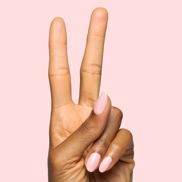 Hand showing peace sign with nails polished in Saltwater Taffy - Gel for a soft sheer pink gel manicure look
