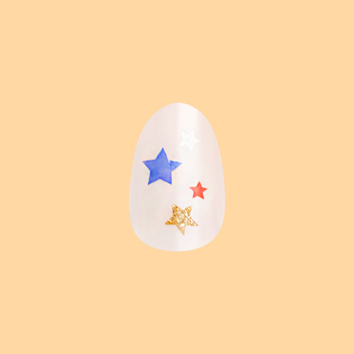 Star Spangled Party - Press-On | Short | Almond showing short almond nail with red, blue, and gold star accents on milky base