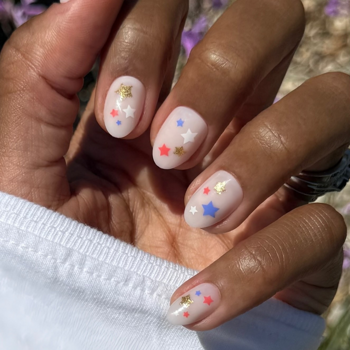 Star Spangled Party - Press-On | Short | Almond with milky base and red, white, blue, and gold star nail art manicure