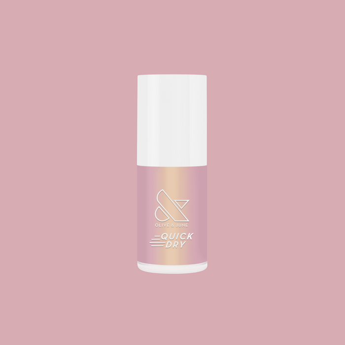 Sugarcoat quick dry polish bottle with sheer shimmery pink iridescent finish on a soft pink background