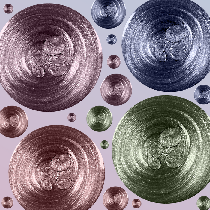 The Magnetics System featuring swirled metallic nail polish shades in purple, blue, green, and bronze for at-home manicure.