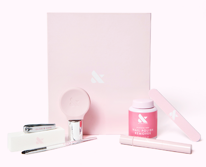 The O&J Mani System - 1 Polish with acetone-free remover, nail file, clipper, and manicure tools in pink packaging by Olive and June