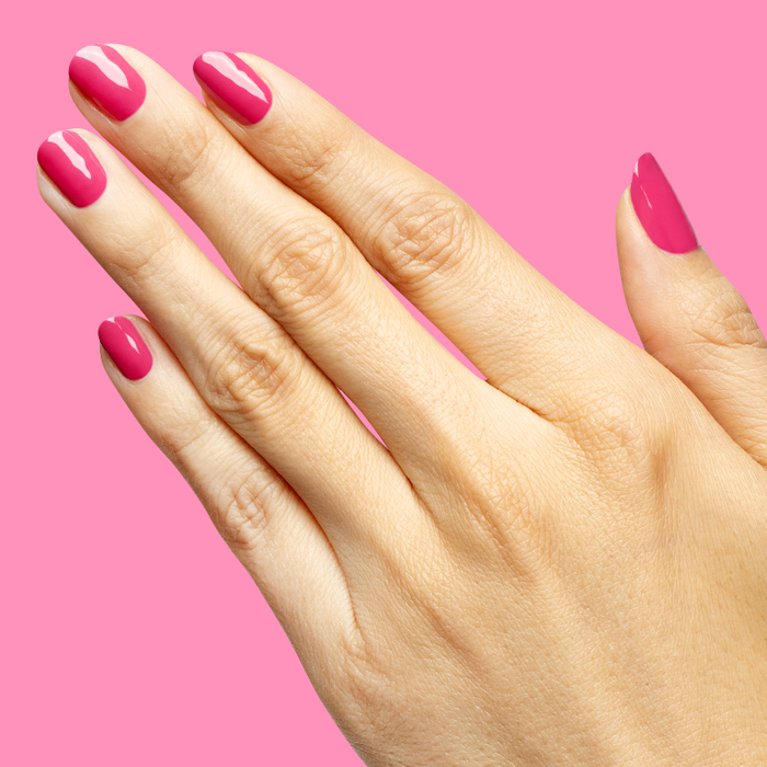 Hand with nails painted in vibrant magenta using Wild Orchid - Gel for a bold, long-lasting manicure at home