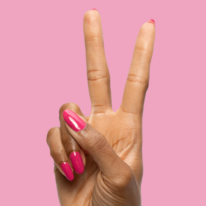XOXO - Gel shown on nails in a bright hot pink shade for a vibrant, long-lasting at-home manicure by Olive and June