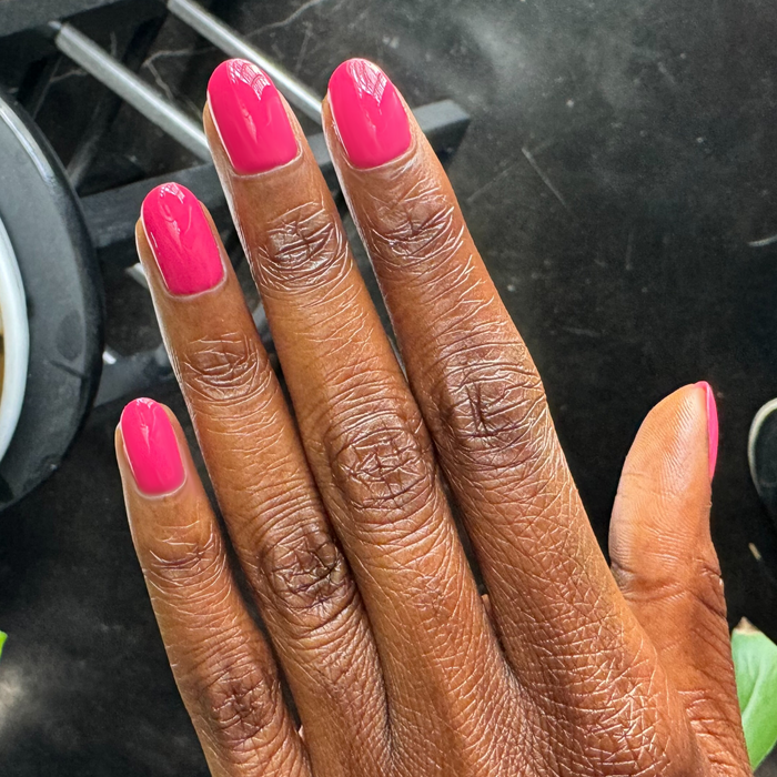 XOXO - Gel shown on nails in a vibrant hot pink shade for a fun, long-lasting at-home manicure by Olive and June