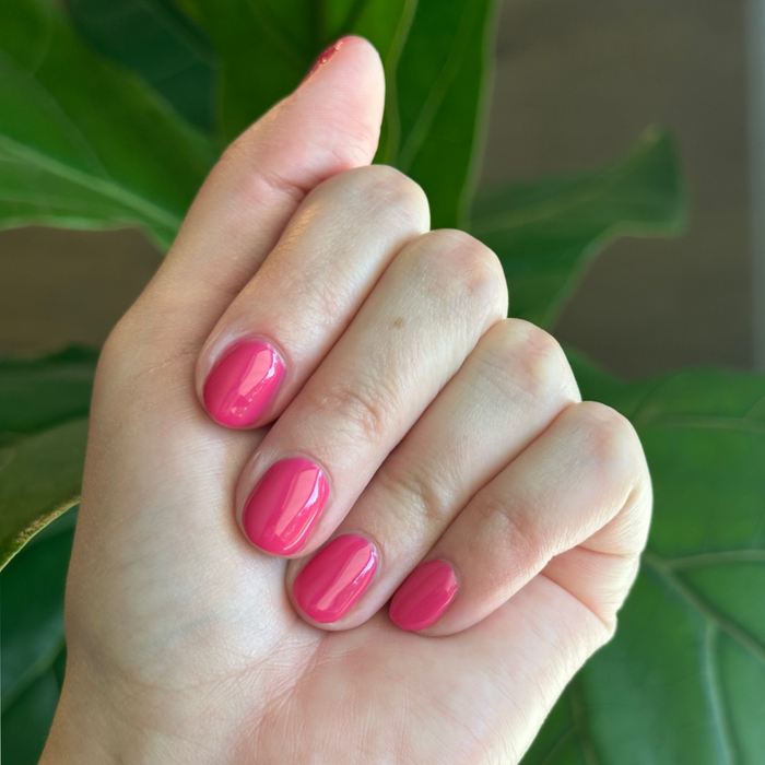 XOXO - Gel shown on nails in a bright hot pink shade for a bold, long-lasting at-home manicure by Olive and June