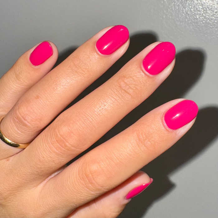 XOXO - Gel shown on nails in a vibrant hot pink shade for a bright, long-lasting at-home manicure by Olive and June